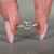 Heart diamond ring with round diamond pave accents.