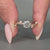 Round cut diamond ring with round side stones in a rose gold band.
