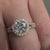 Round diamond engagement ring with cathedral setting.
