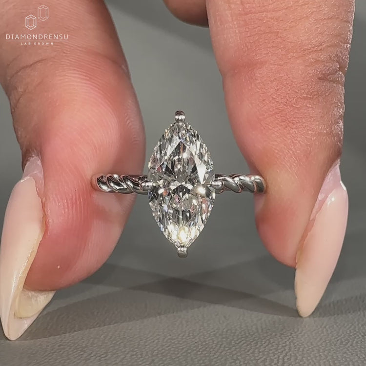 Marquise diamond ring twisted pave compass prong set.
