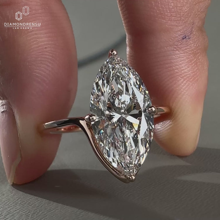 Beautiful compass prong ring with a marquise diamond in rose gold.