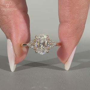 Oval diamond ring round side stones tapered shank.
