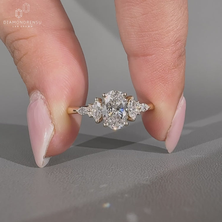 Oval diamond ring marquise round stones tapered shank.

