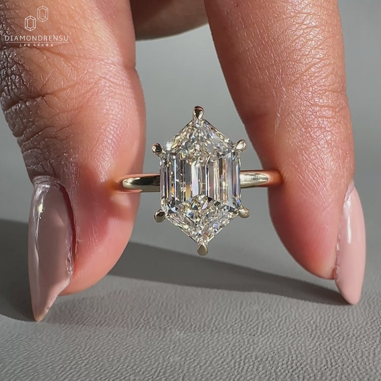 Hexagon engagement ring crafted in yellow gold with a solitaire diamond.
