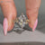 Marquise ring round side stones design.