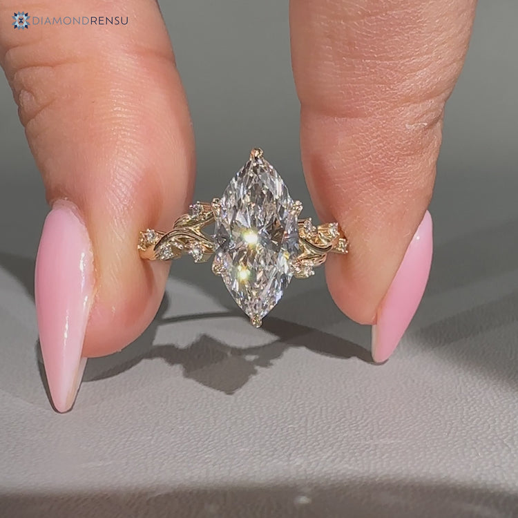Marquise ring round side stones design.