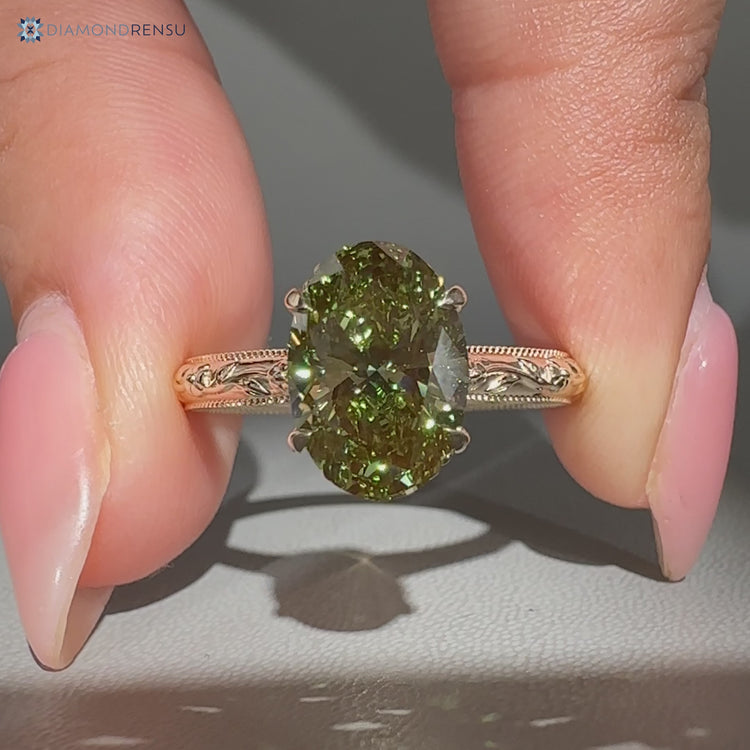 Green diamond oval ring with bridge accent.