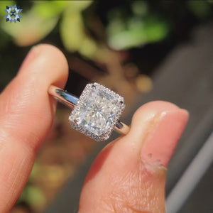 Halo ring setting surrounding a radiant cut diamond with brilliant detailing
