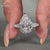 Pear cut diamond ring with milgrain setting and cathedral design.
