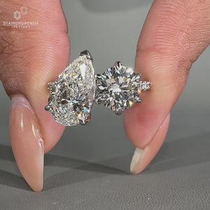 Pear and round diamond ring with pavé accents in white gold band.
