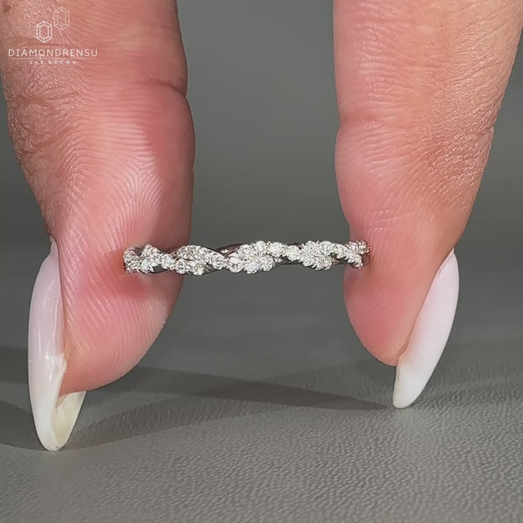 Diamond twist eternity ring with round stones.