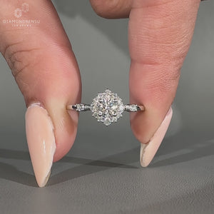 Round diamond ring halo style cluster four prong set.

