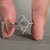 Round cut halo setting in white gold engagement ring.
