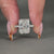 4 claw prong setting holds round cut diamond.

