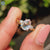 Pear Rose Cut Ring with round side stones and a claw prong ring setting in yellow gold.

