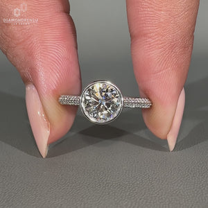 Handmade bezel diamond ring with two row pave band.
