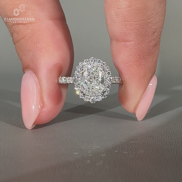 Handmade elongated cushion cut diamond ring with pave band.
