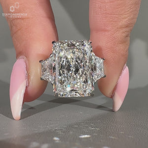 Radiant cut engagement ring with trapezoid side stone and 4 claw prong.