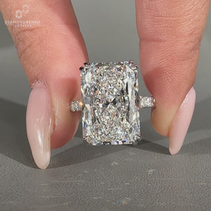 Pave round diamond ring featuring radiant cut centre stone.