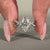 Twisted pavé engagement ring with marquise centre and round diamond accents.

