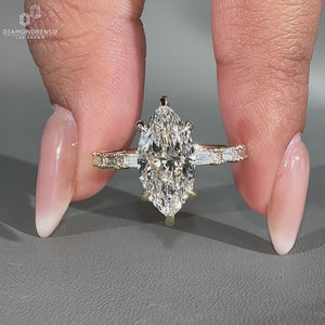 Baguette and round cut side stone in yellow gold engagement ring.
