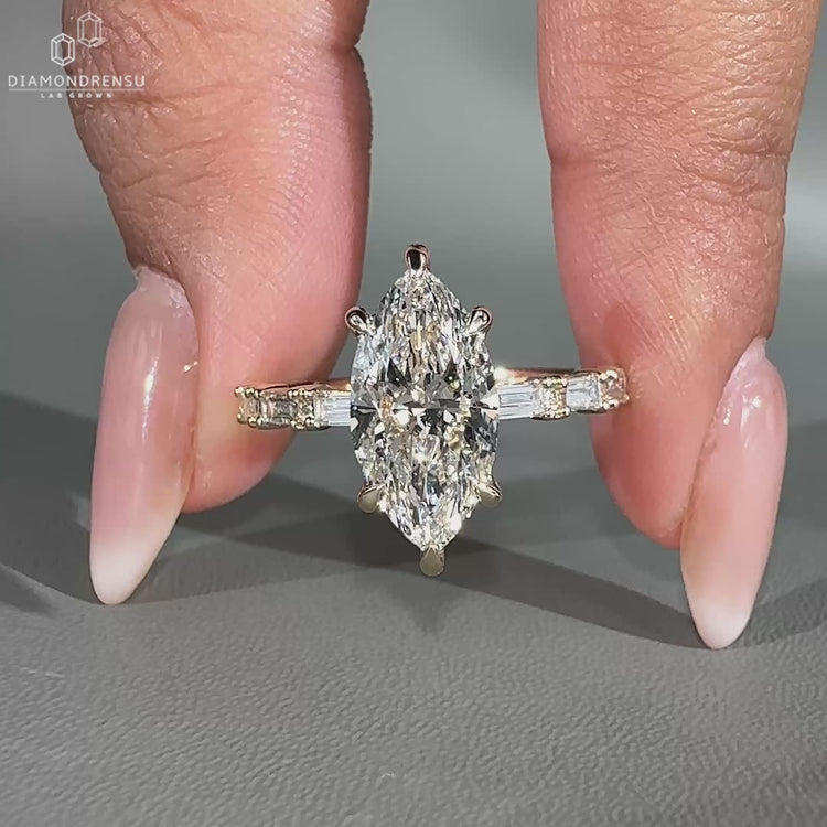 Baguette and round cut side stone in yellow gold engagement ring.
