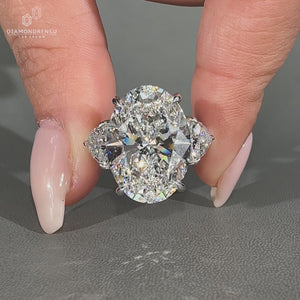 Oval diamond ring featuring trillion cut diamond side stones.