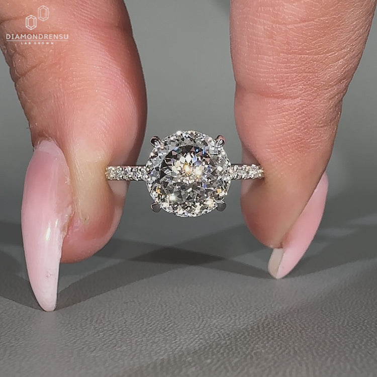 Portuguese cut ring pave round diamond four claw set.
