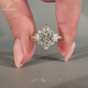 Handmade marquise cut diamond ring with round side stones.

