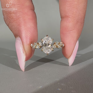 Oval diamond ring cluster round side stones vintage.
