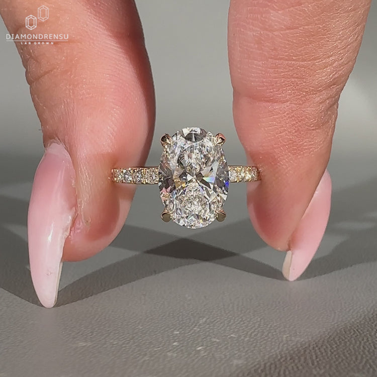 Oval diamond ring hidden halo pave round diamond.
