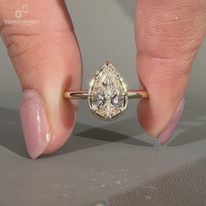 Pear diamond ring solitaire bezel prong vintage style.
