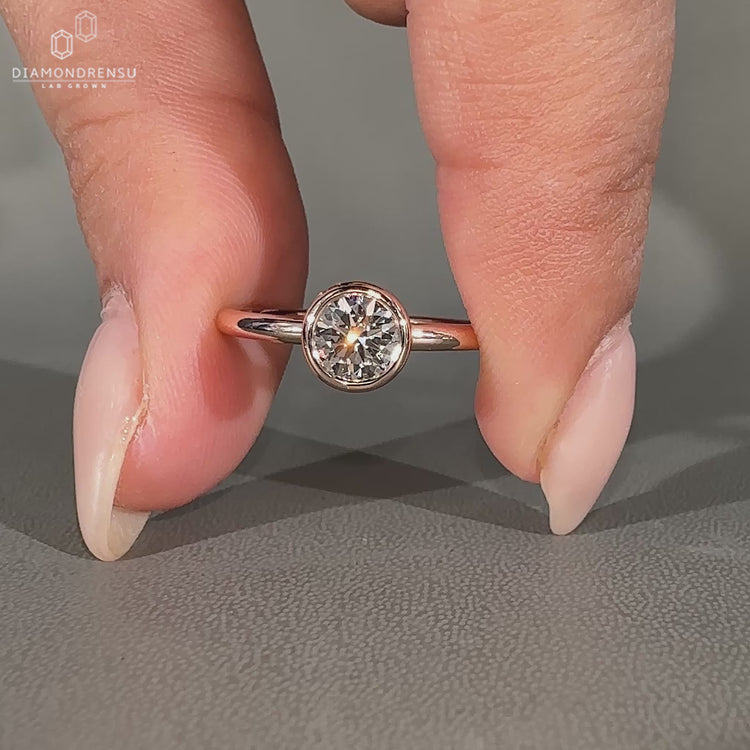 Handmade solitaire ring featuring a round lab grown diamond.
