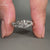 Round diamond ring with split shank and solitaire setting.
