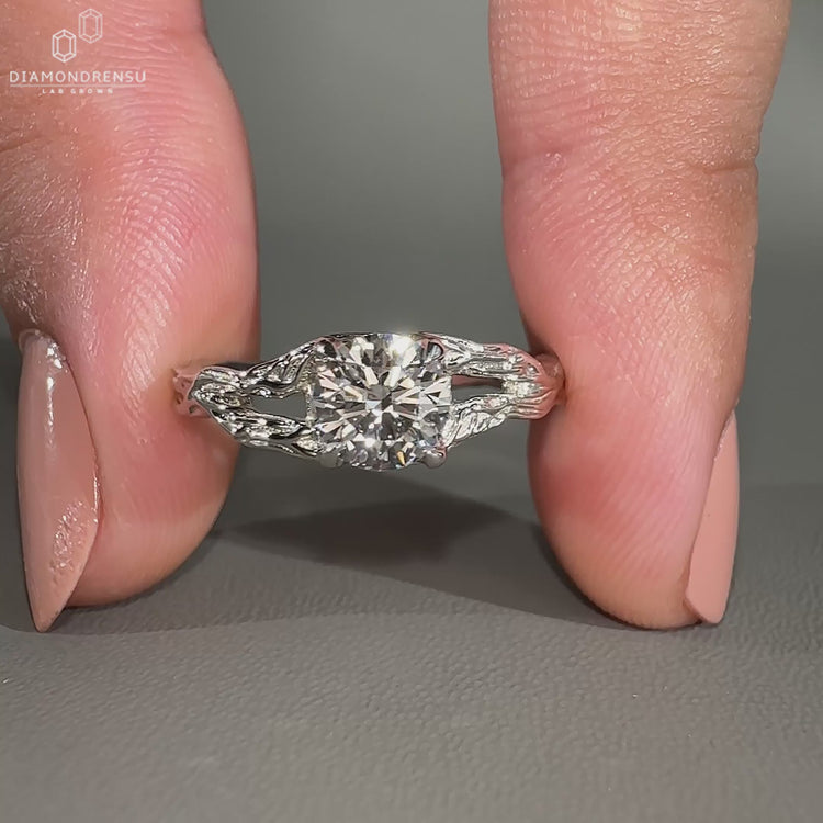 Round diamond ring with split shank and solitaire setting.
