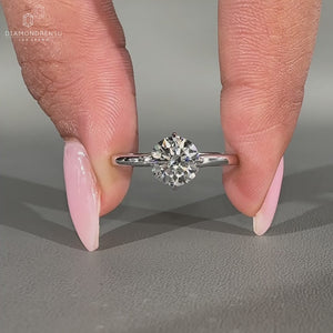 Solitaire engagement ring with compass prong setting.

