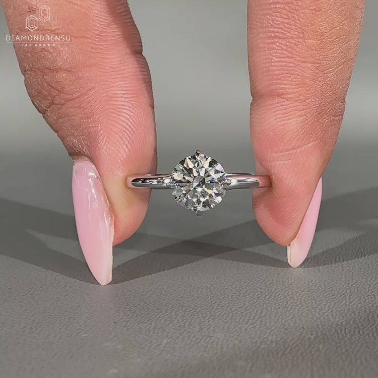 Solitaire engagement ring with compass prong setting.

