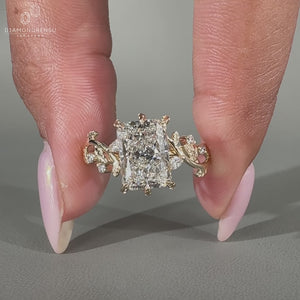Cluster engagement ring featuring marquise and round side stones.
