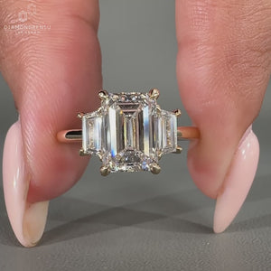 3 stone engagement ring with trapezoid side stone.
