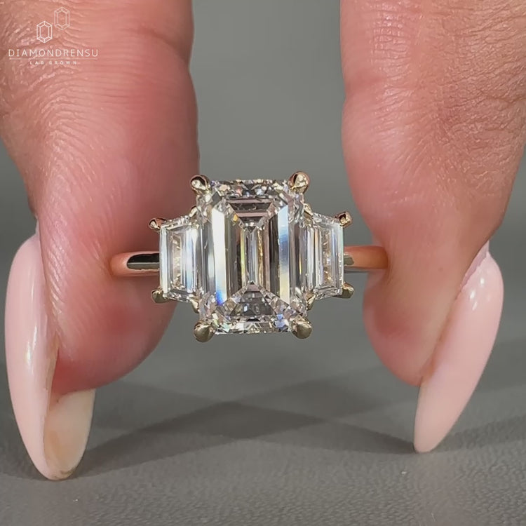 3 stone engagement ring with trapezoid side stone.

