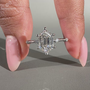 hexagon step cut ring with round diamond side stones.
