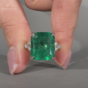 Emerald ring round side stones seven stone setting.
