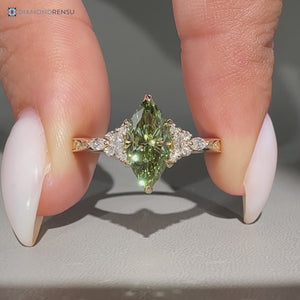 Green diamond ring with marquise and round side stones.