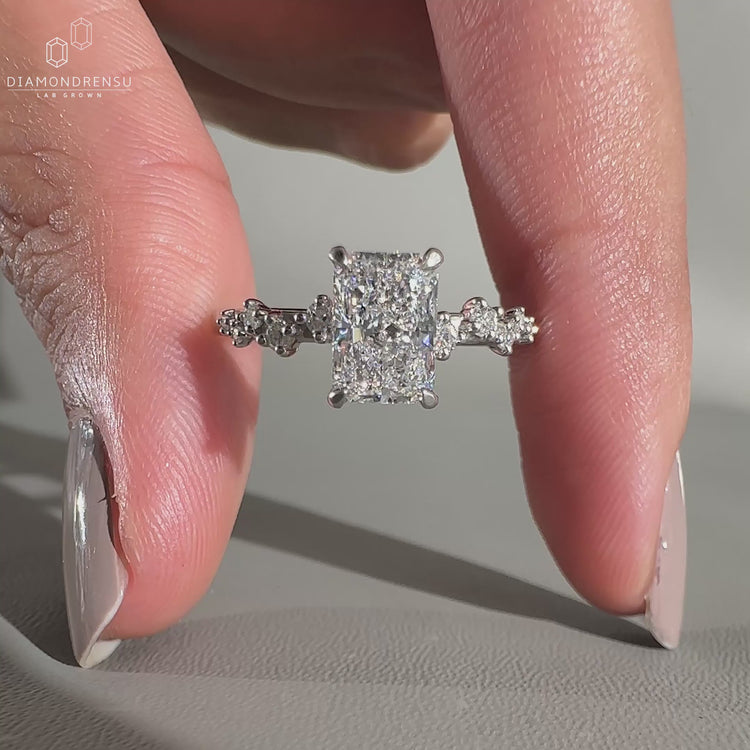Radiant cut diamond ring in zig zag pave setting.
