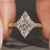 Marquise diamond ring with six claw prong setting.