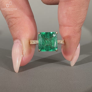 Asscher cut emerald ring cathedral milgrain prong set.
