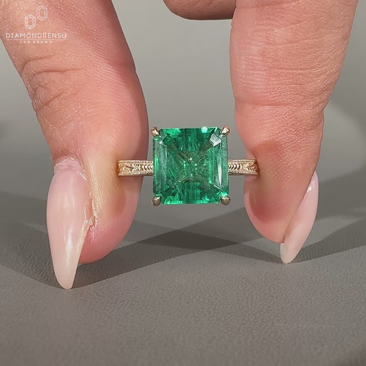 Asscher cut emerald ring cathedral milgrain prong set.
