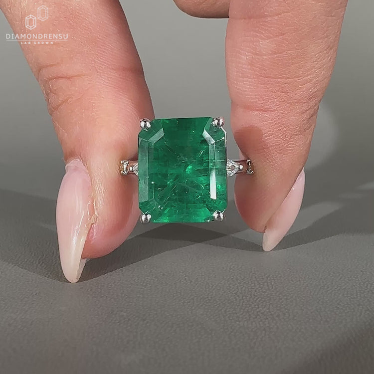 Emerald gemstone ring marquise round pave prong set.
