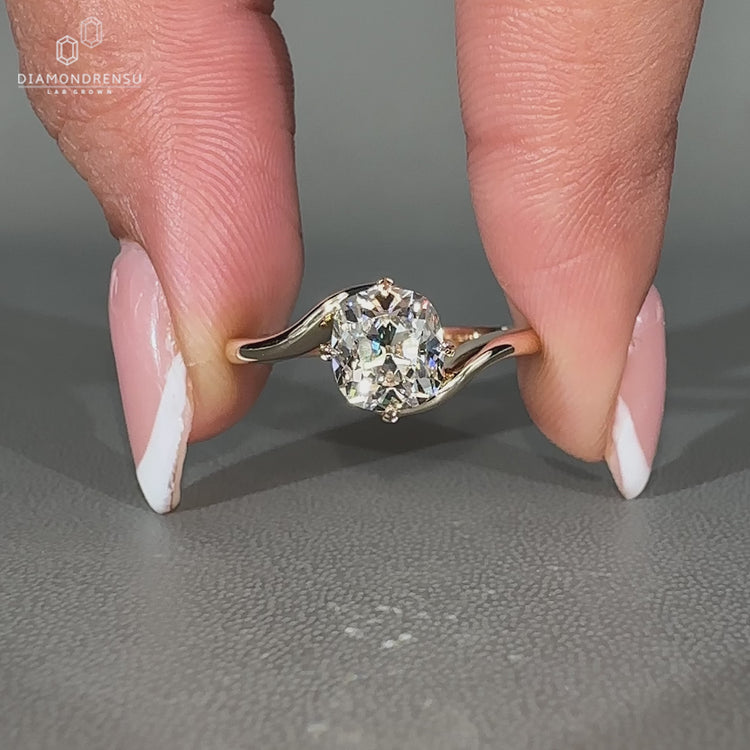 Handmade solitaire diamond ring with compass prong setting.