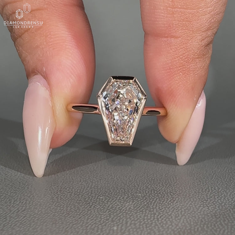 Coffin diamond ring solitaire bezel setting style.